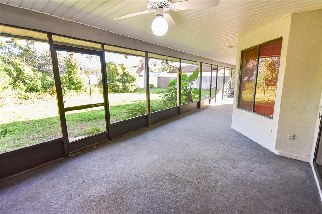 8143 Wooden Drive Spring Hill, FL 34606 - Photo 33 of 36 a view of an empty room with a floor to ceiling window