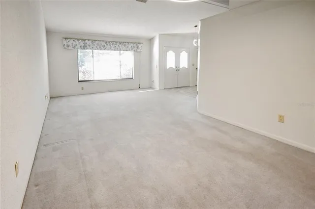 a living room with a couch and a chandelier