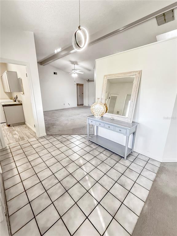 8143 Wooden Drive Spring Hill, FL 34606 - Photo 8 of 36 a living room with a couch and a chandelier