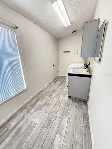 a view of a kitchen with refrigerator and windows