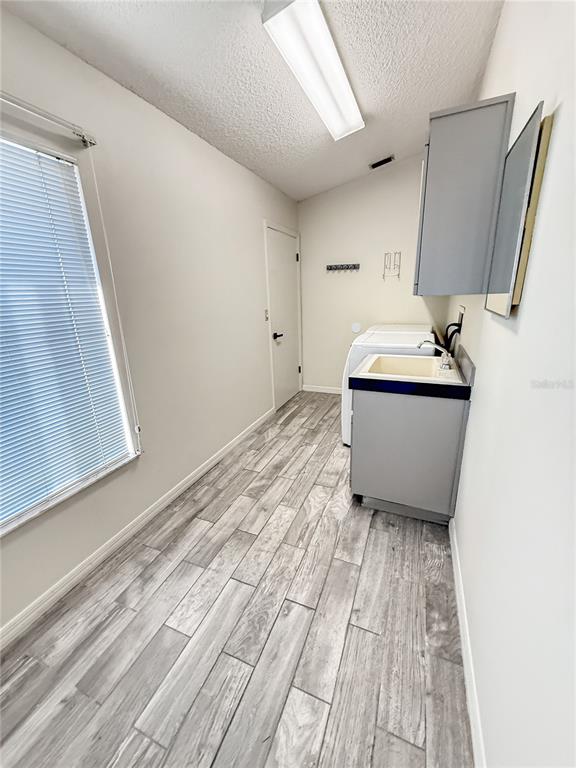 8143 Wooden Drive Spring Hill, FL 34606 - Photo 9 of 36 a room with wooden floor washer and dryer