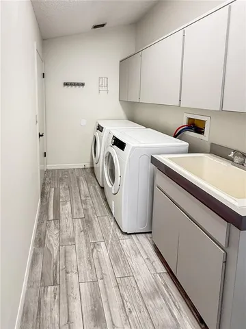 a kitchen with stainless steel appliances a refrigerator sink and cabinets