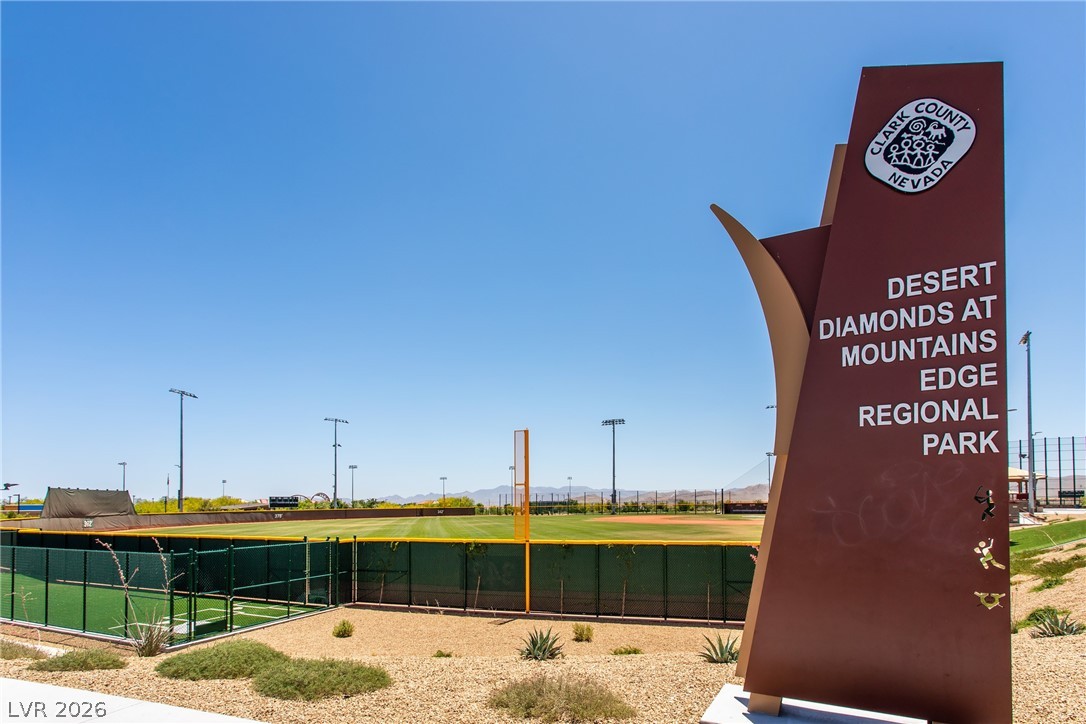 7375 Campbell Ranch Avenue Las Vegas, NV 89179 - Photo 39 of 45 An inviting sign marks the entrance to a well-maintained regional park, featuring a pristine baseball field under a clear sky.