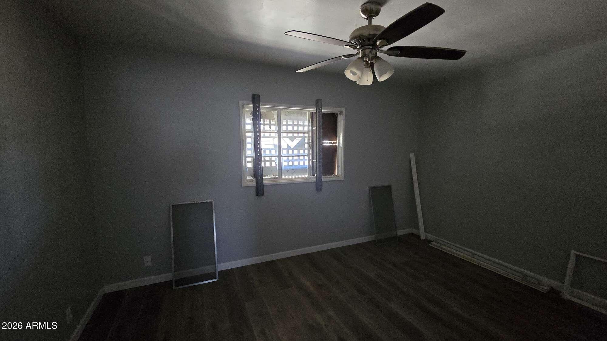 834 West Osborn Road Phoenix, AZ 85013 - Photo 24 of 45 an empty room with wooden floor fan and windows