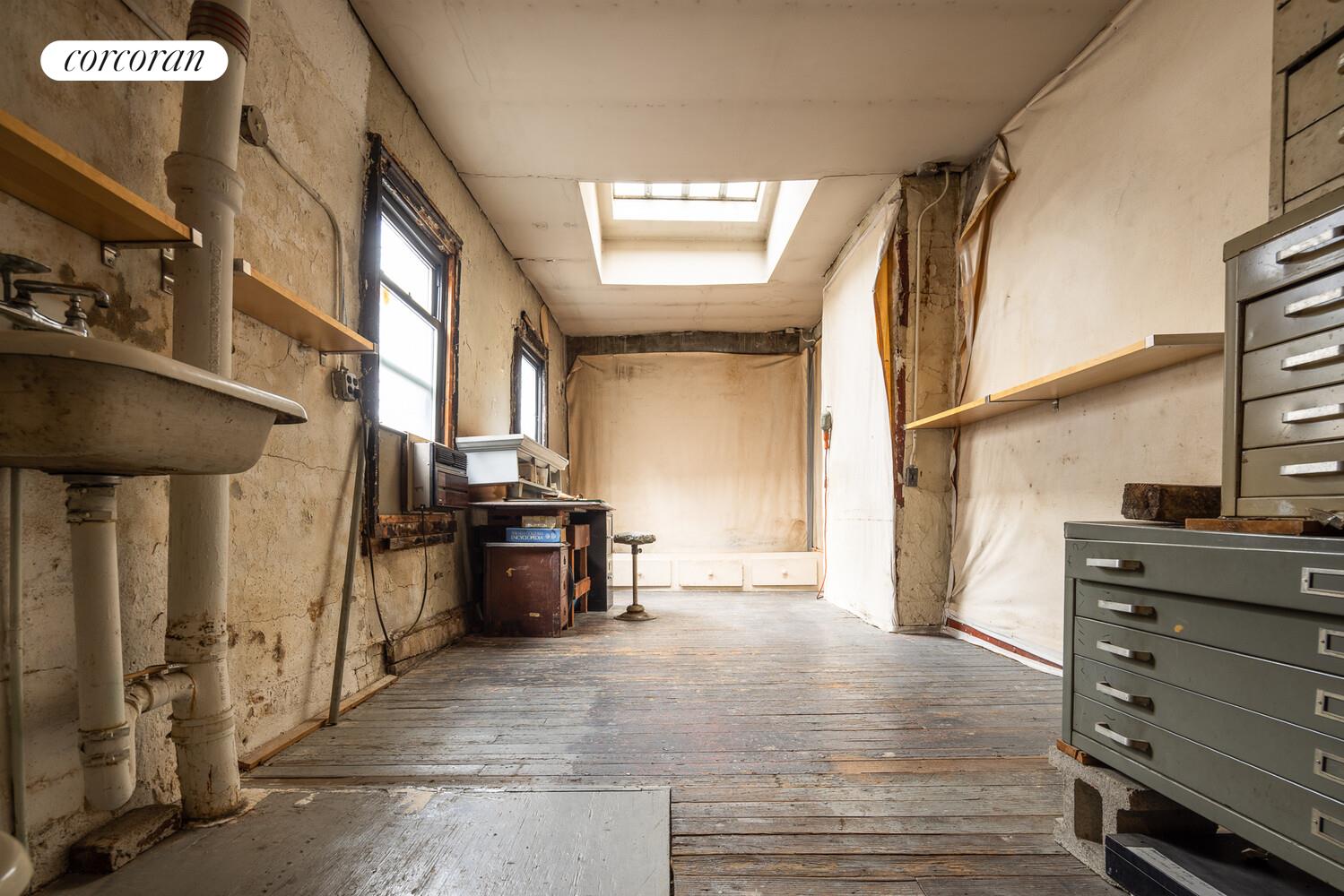 7 Bleecker Street Manhattan, NY 10012 - Photo 13 of 15 a view of a hallway with closet and cabinet