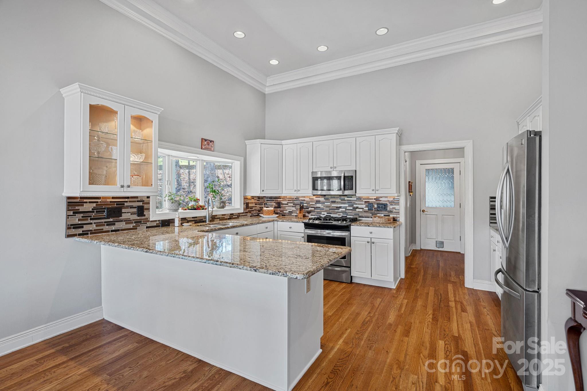 213 Patternote Road Mooresville, NC 28117 - Photo 13 of 48 a kitchen with stainless steel appliances granite countertop a sink stove and refrigerator