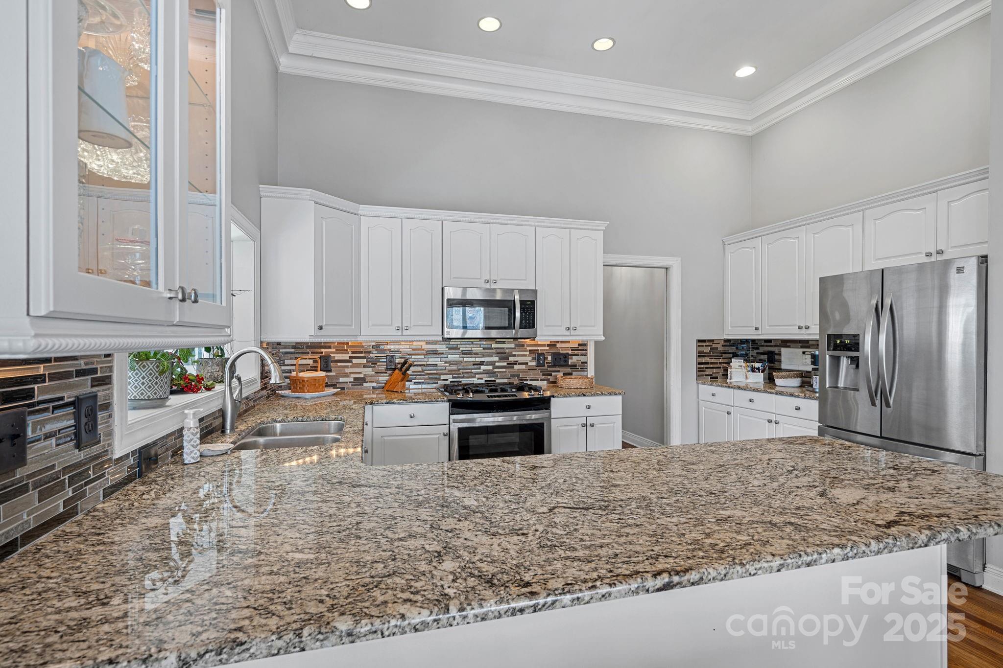 213 Patternote Road Mooresville, NC 28117 - Photo 14 of 48 a kitchen with stainless steel appliances granite countertop a stove refrigerator sink and cabinets