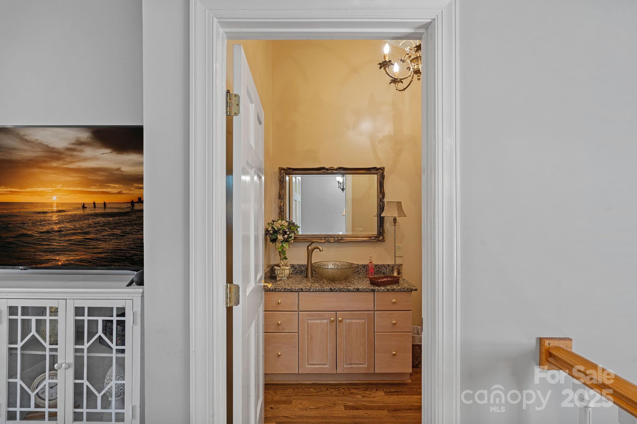 213 Patternote Road Mooresville, NC 28117 - Photo 22 of 48 a bathroom with a granite countertop sink and a mirror