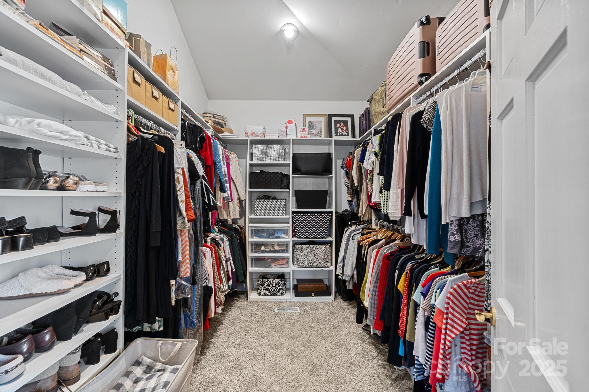 213 Patternote Road Mooresville, NC 28117 - Photo 25 of 48 a view of walk in closet with clothes and shoes