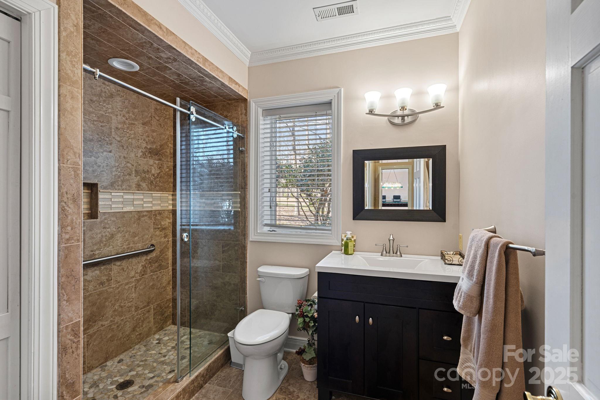 213 Patternote Road Mooresville, NC 28117 - Photo 36 of 48 a bathroom with a sink toilet a mirror and shower