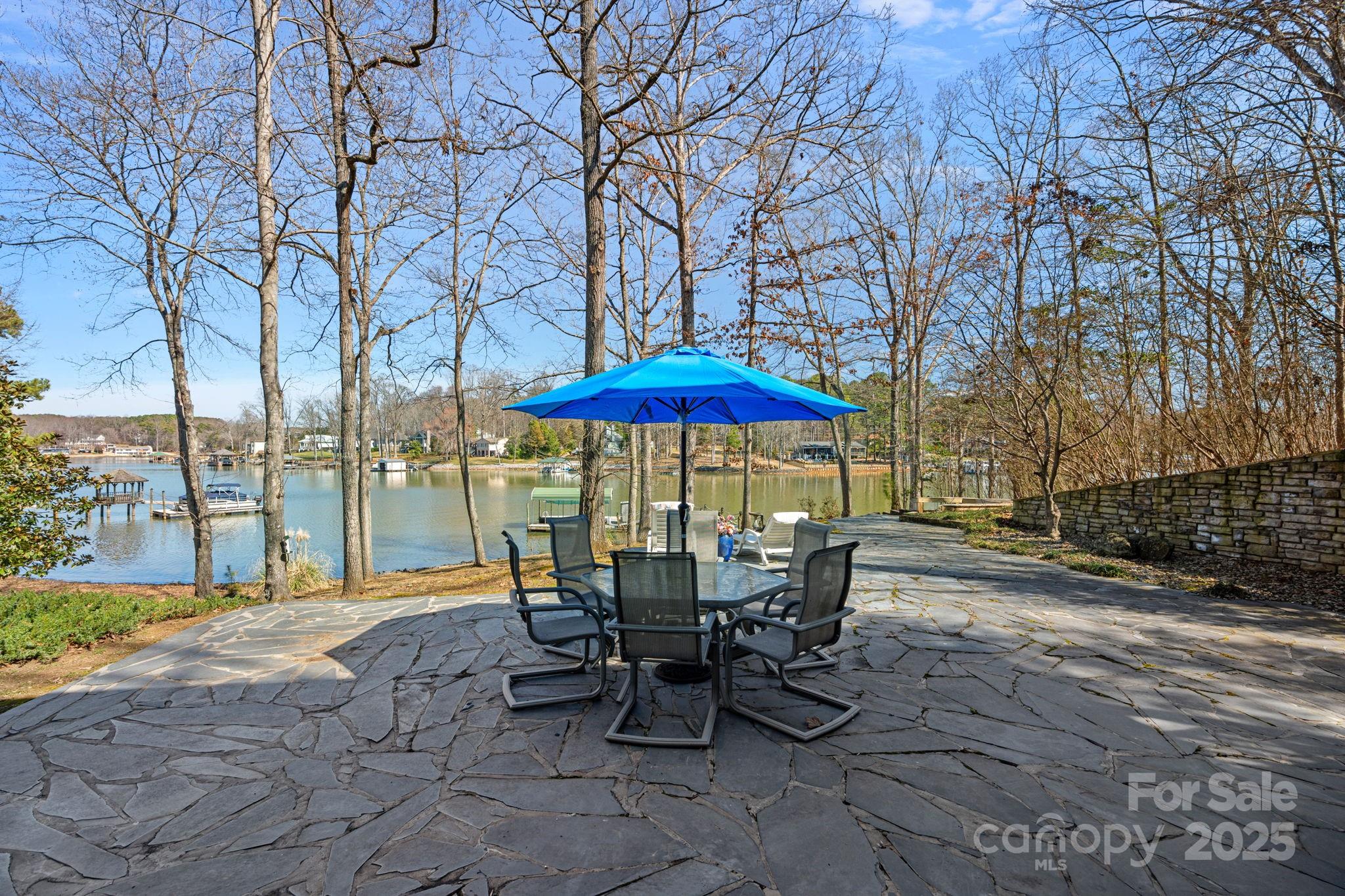 213 Patternote Road Mooresville, NC 28117 - Photo 39 of 48 a view of a patio with a table and chairs under an umbrella