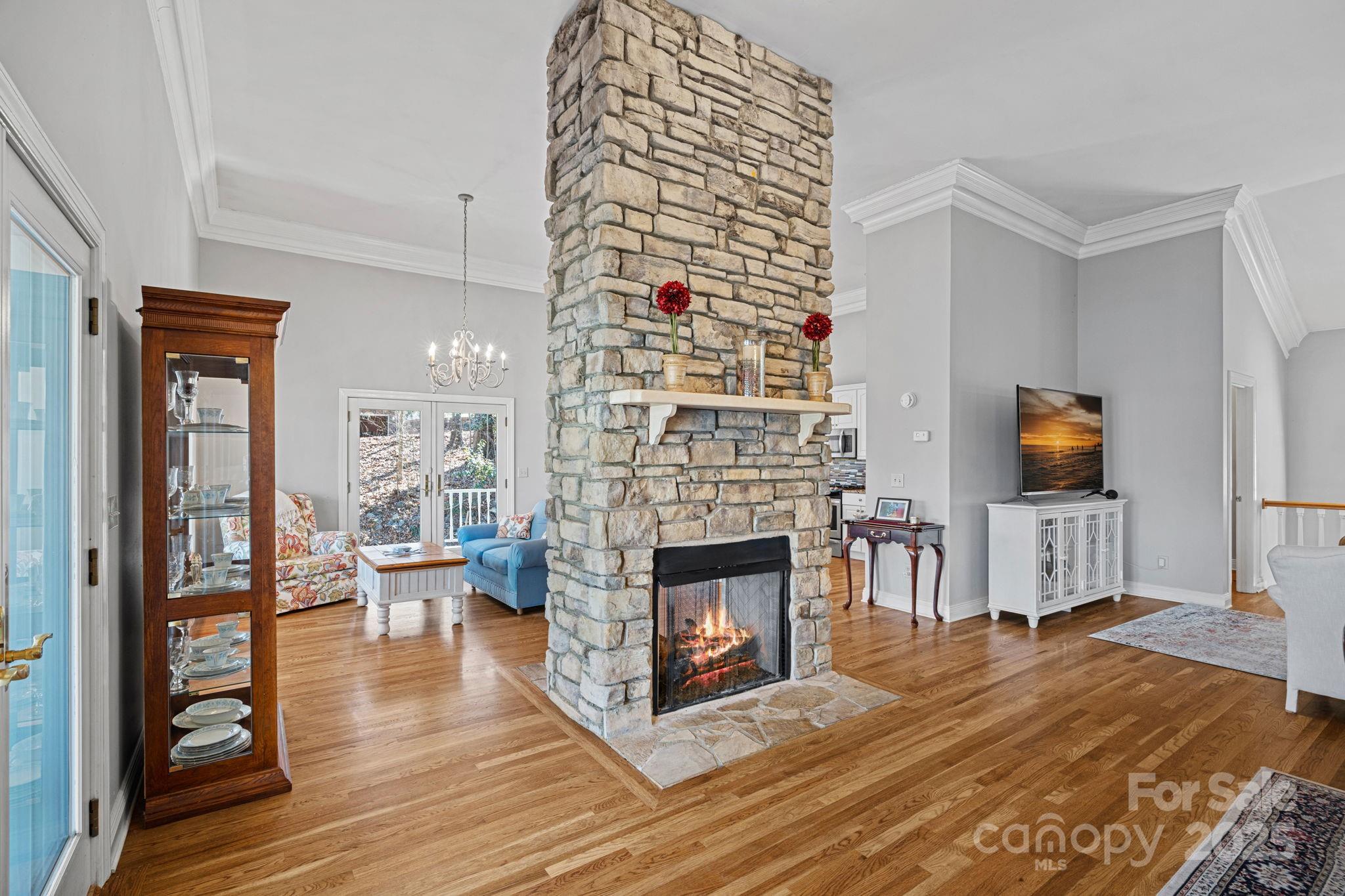 213 Patternote Road Mooresville, NC 28117 - Photo 10 of 48 a living room with furniture a fireplace and a flat screen tv