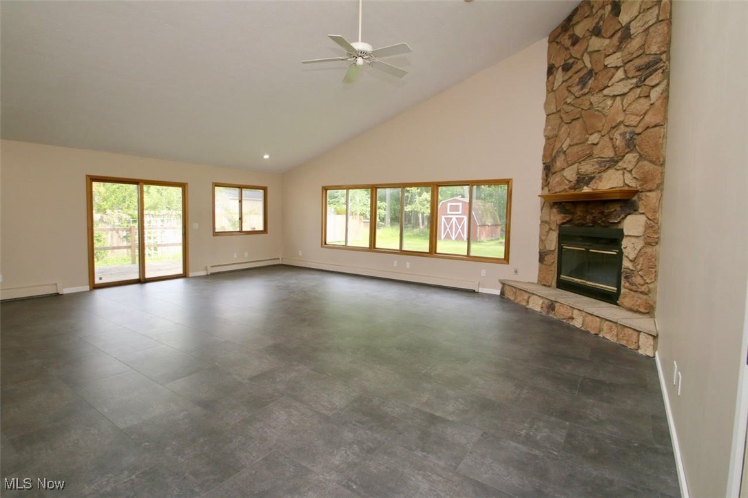 7958 Bellflower Road Mentor, OH 44060 - Photo 4 of 34 Unfurnished living room featuring a ceiling fan, high vaulted ceiling, a fireplace, and baseboard heating