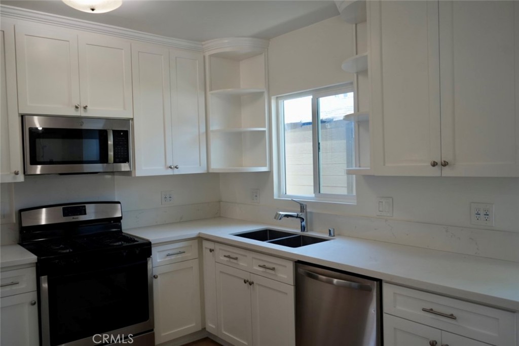 2117 Verde Street Pasadena, CA 91107 - Photo 7 of 13 a kitchen with granite countertop white cabinets and black appliances