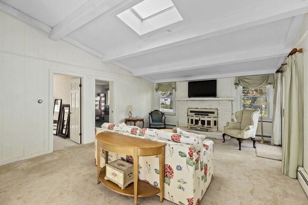 7 Zora Road Marion, MA 02738 - Photo 13 of 38 a living room with furniture a fireplace and a flat screen tv