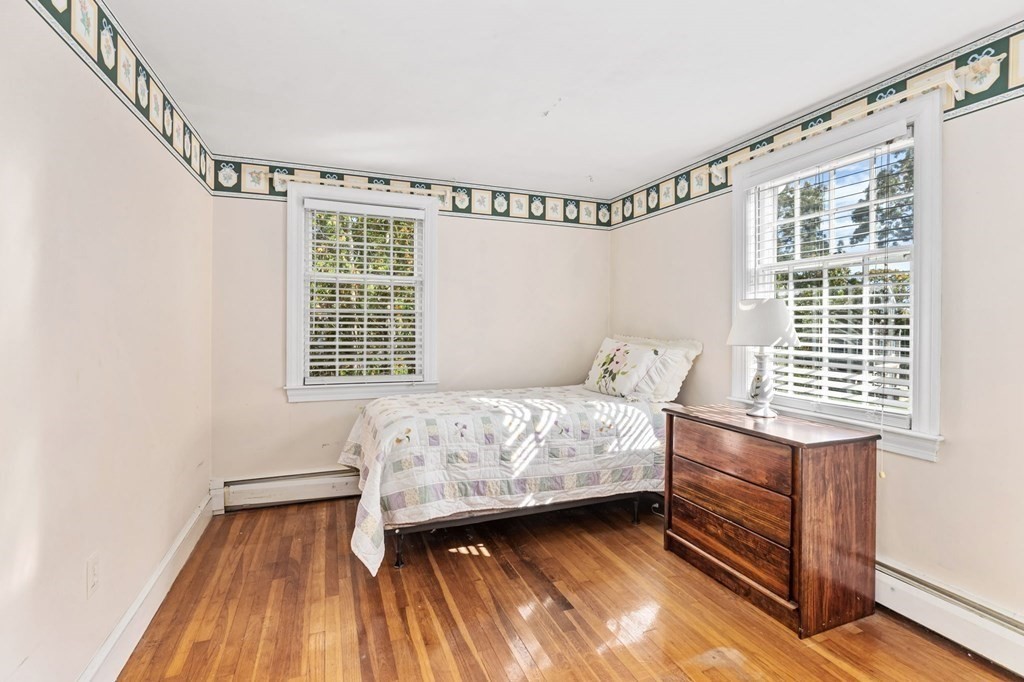 7 Zora Road Marion, MA 02738 - Photo 14 of 38 a bedroom with a bed and wooden floor