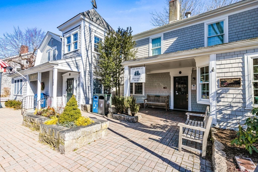 7 Zora Road Marion, MA 02738 - Photo 20 of 38 a view of a white house with chairs in front of retail shop