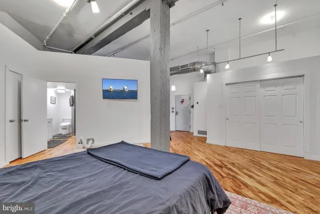 a bedroom with a large bed and a chandelier