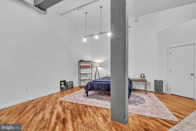 a bedroom with a bed and a chandelier