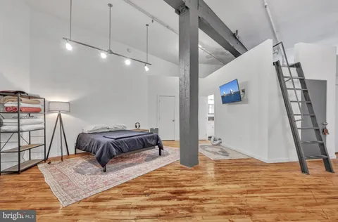 a bedroom with furniture and a rug