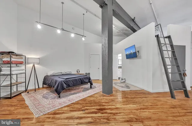 a bedroom with furniture and a rug