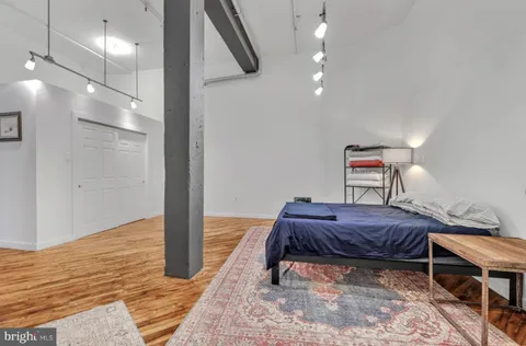 a bedroom with a bed and cabinets