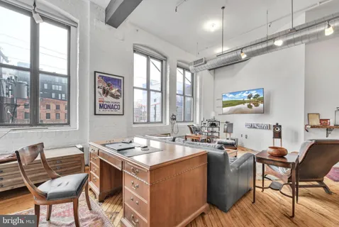 a view of a dining room with furniture a chandelier and wooden floor