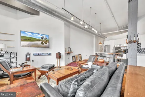 a living room with furniture a rug and a chandelier