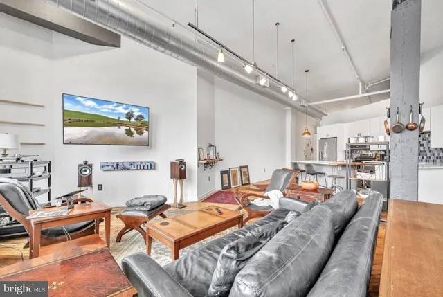 a living room with furniture a rug and a chandelier