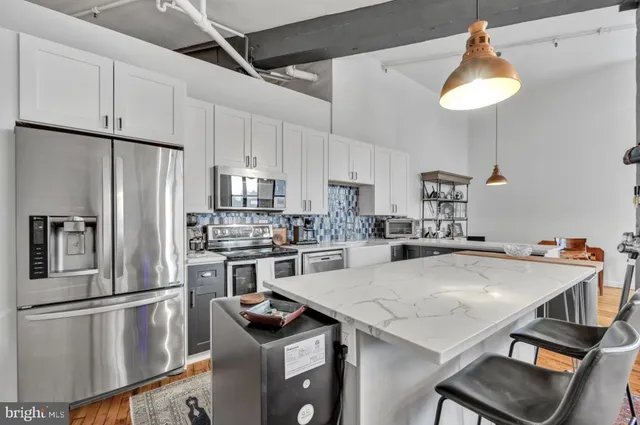 a kitchen with kitchen island a table and chairs