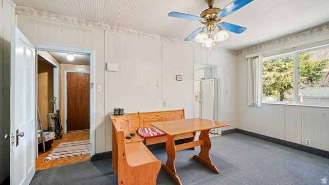 44 Shriver Street Eureka, UT 84628 - Photo 14 of 43 Dining area featuring a picture window, white paneled walls with wallpaper trim, a textured ceiling, and a ceiling fan with light fixture