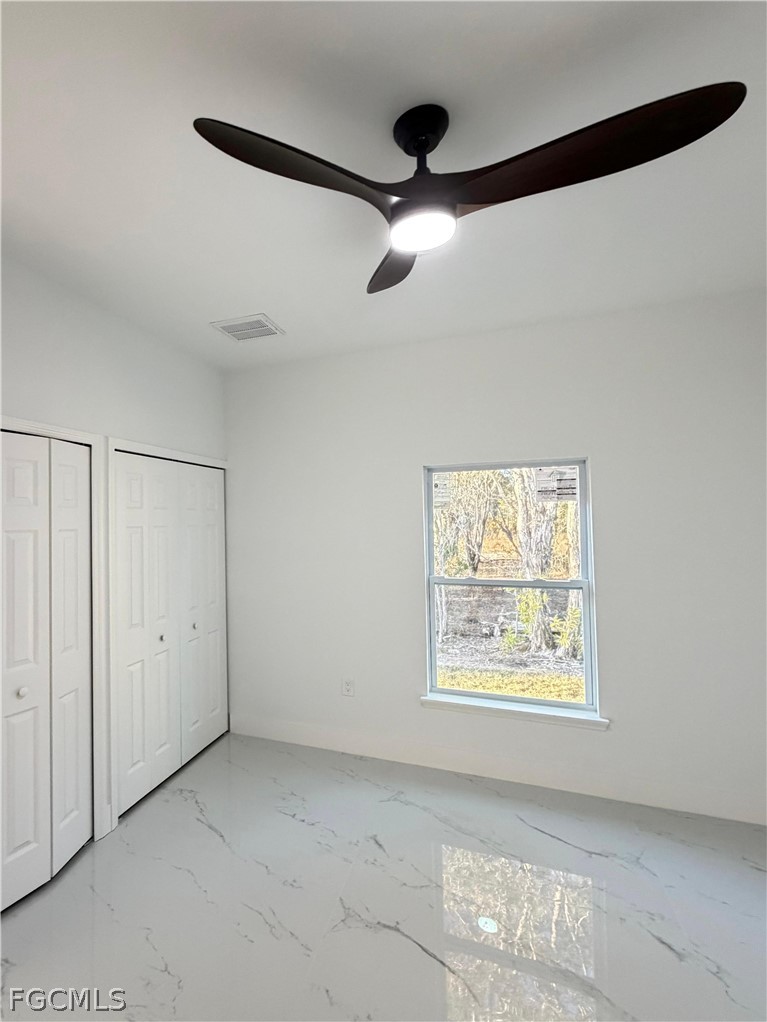 767 Crystal Avenue Lehigh Acres, FL 33974 - Photo 12 of 17 an empty room with windows