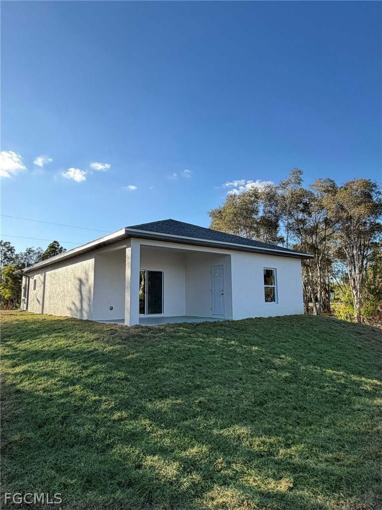 767 Crystal Avenue Lehigh Acres, FL 33974 - Photo 15 of 17 a view of a house with a yard