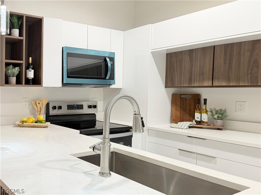 767 Crystal Avenue Lehigh Acres, FL 33974 - Photo 3 of 17 a kitchen with a sink cabinets and appliances