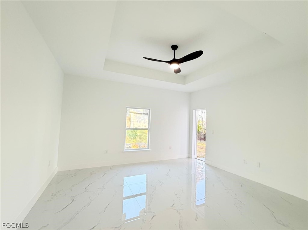 767 Crystal Avenue Lehigh Acres, FL 33974 - Photo 8 of 17 an empty room with a window and a ceiling fan