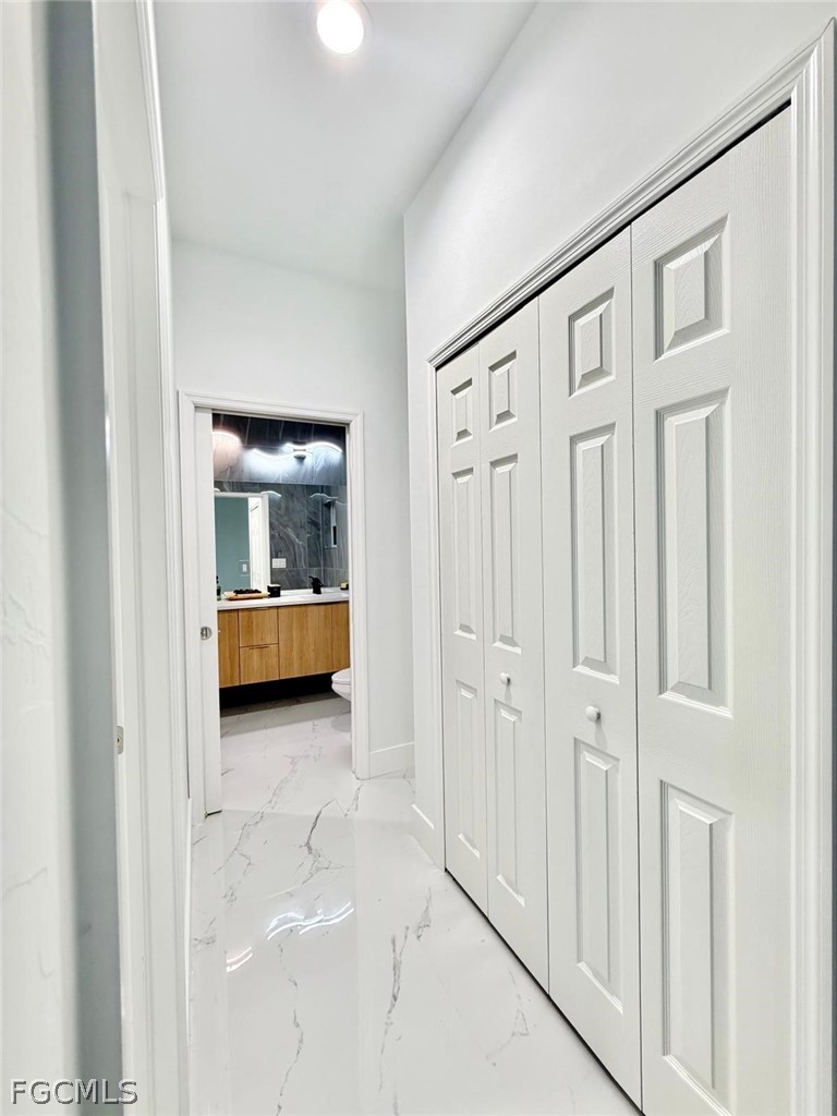 767 Crystal Avenue Lehigh Acres, FL 33974 - Photo 9 of 17 a view of a hallway with closet and cabinet