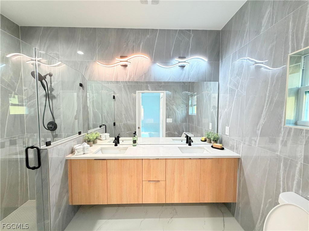 767 Crystal Avenue Lehigh Acres, FL 33974 - Photo 10 of 17 a bathroom with a sink double vanity and mirror