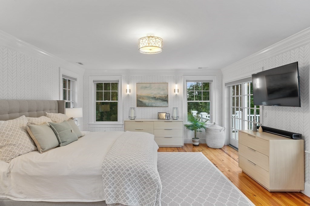 95 Westford Road Concord, MA 01742 - Photo 21 of 42 a bedroom with a large bed and a flat tv screen on dresser