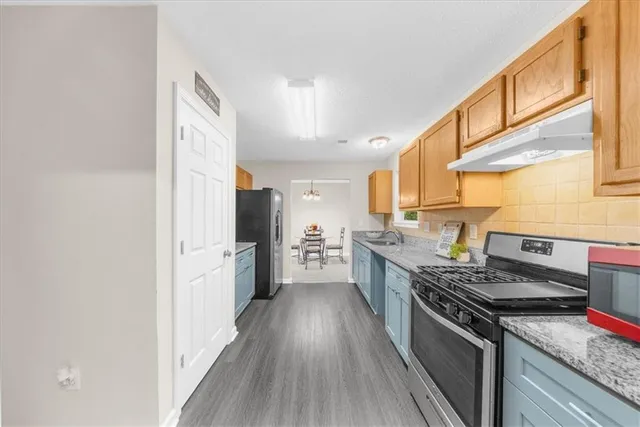 a kitchen with a stove a sink and a refrigerator