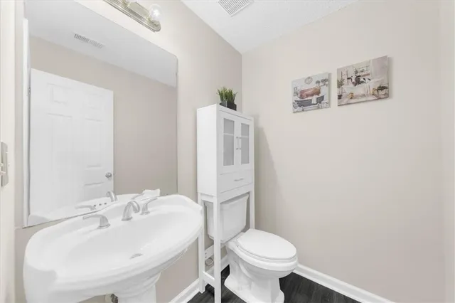 a bathroom with a sink toilet and a mirror