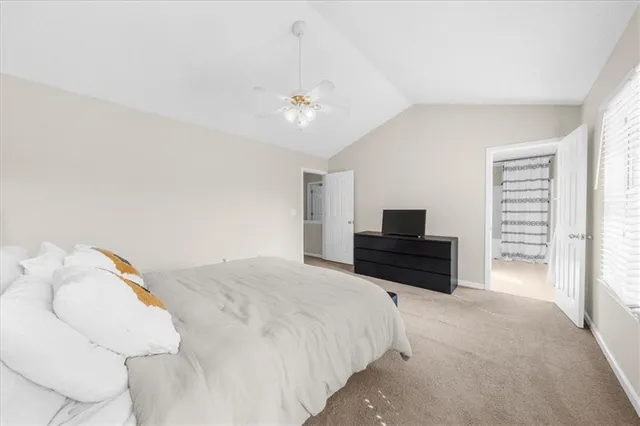 a bedroom with a bed and a television