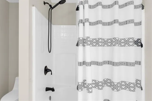 a bathroom with a shower and a shower