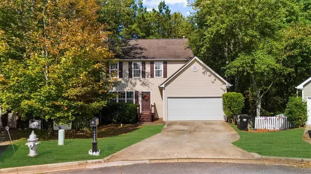 a view of house with yard and green space
