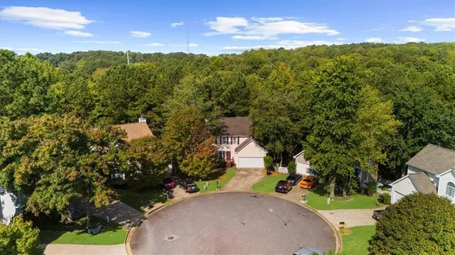 an aerial view of a house with a yard basket ball court and outdoor seating