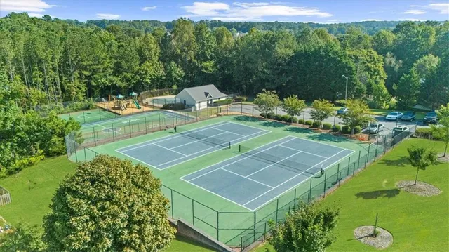 an aerial view of a swimming pool with yard