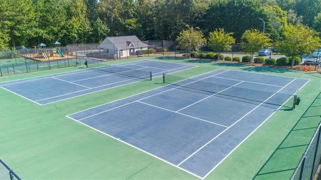 a front view of a house with a garden and plants