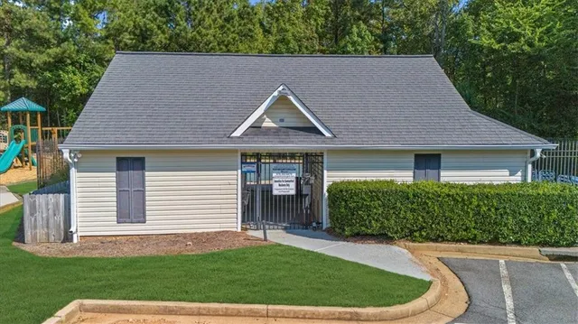 a view of a tennis ground with a small pool