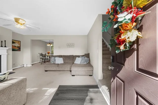 a living room with furniture and flowers