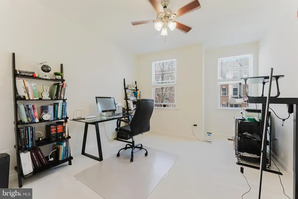 a view of a workspace with furniture and a window