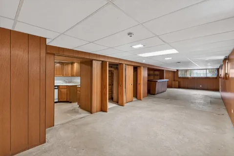 a view of empty room with wooden walls